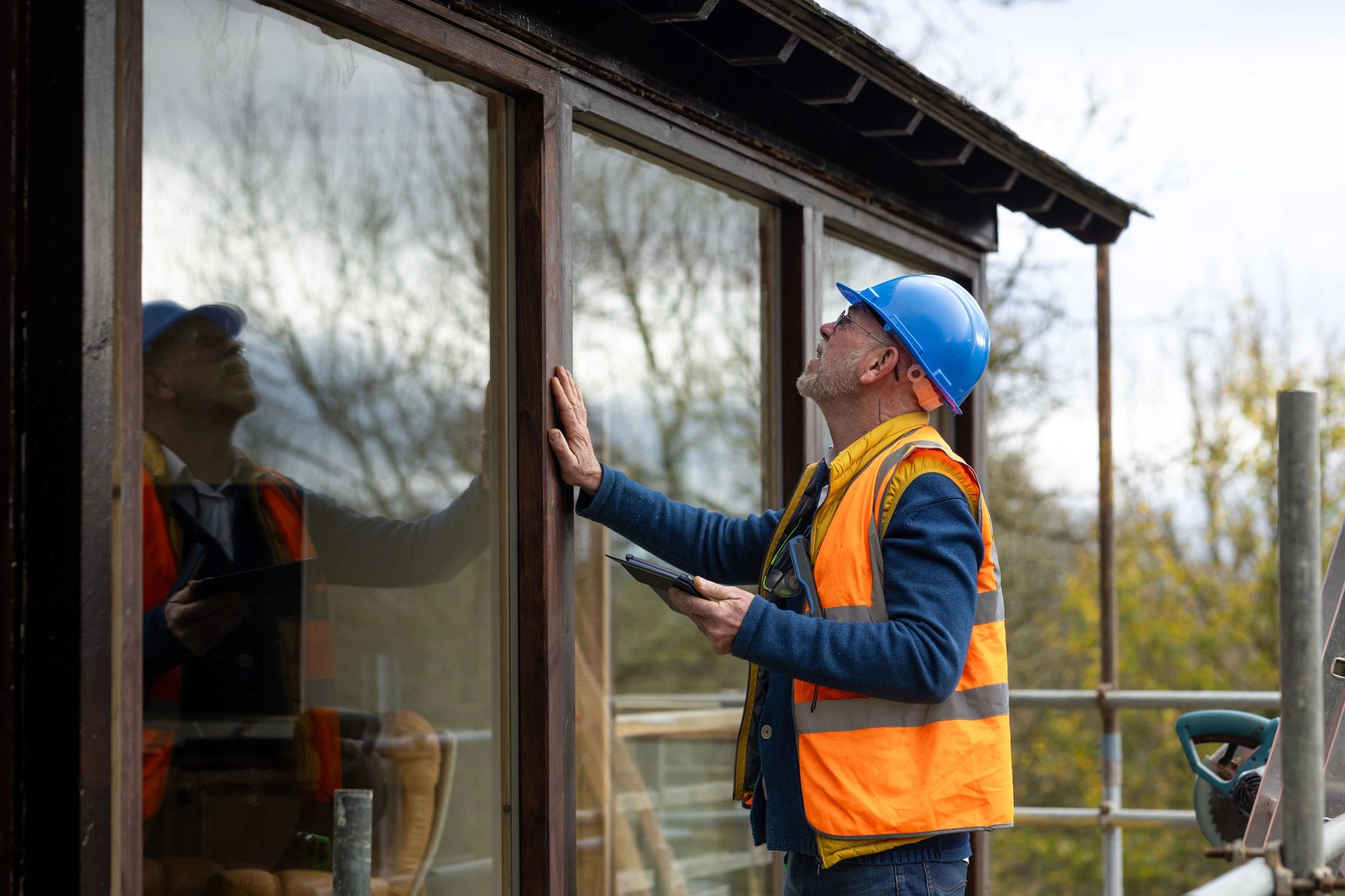 Property manager inspecting newly installed windows during a repair review