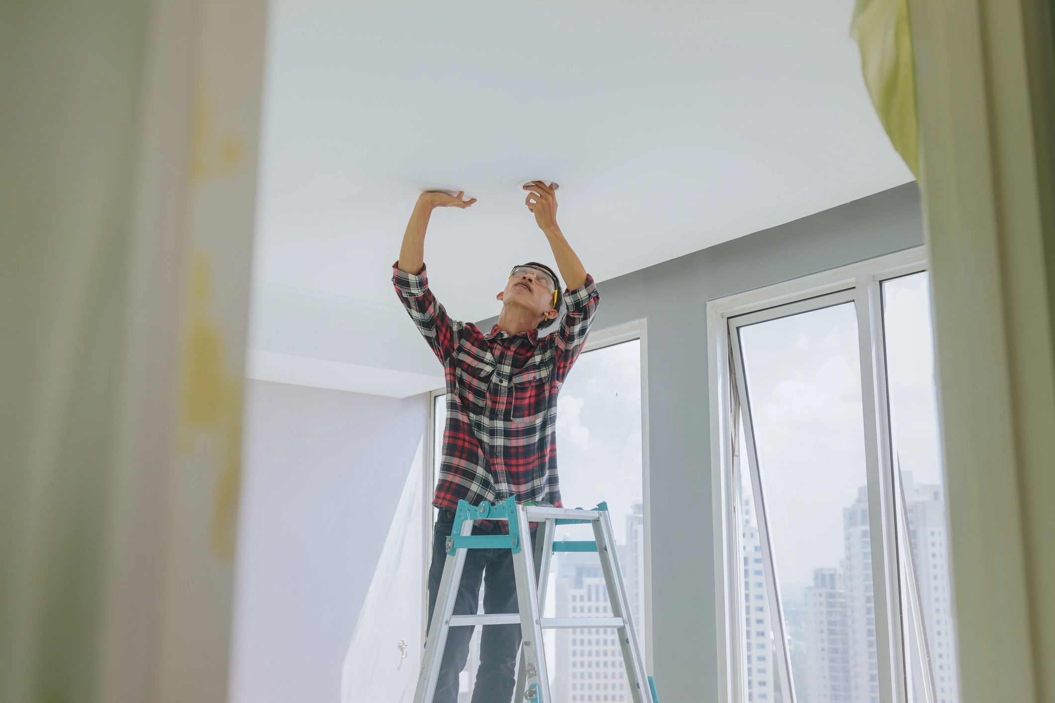 Technician performing maintenance work inside a rental home